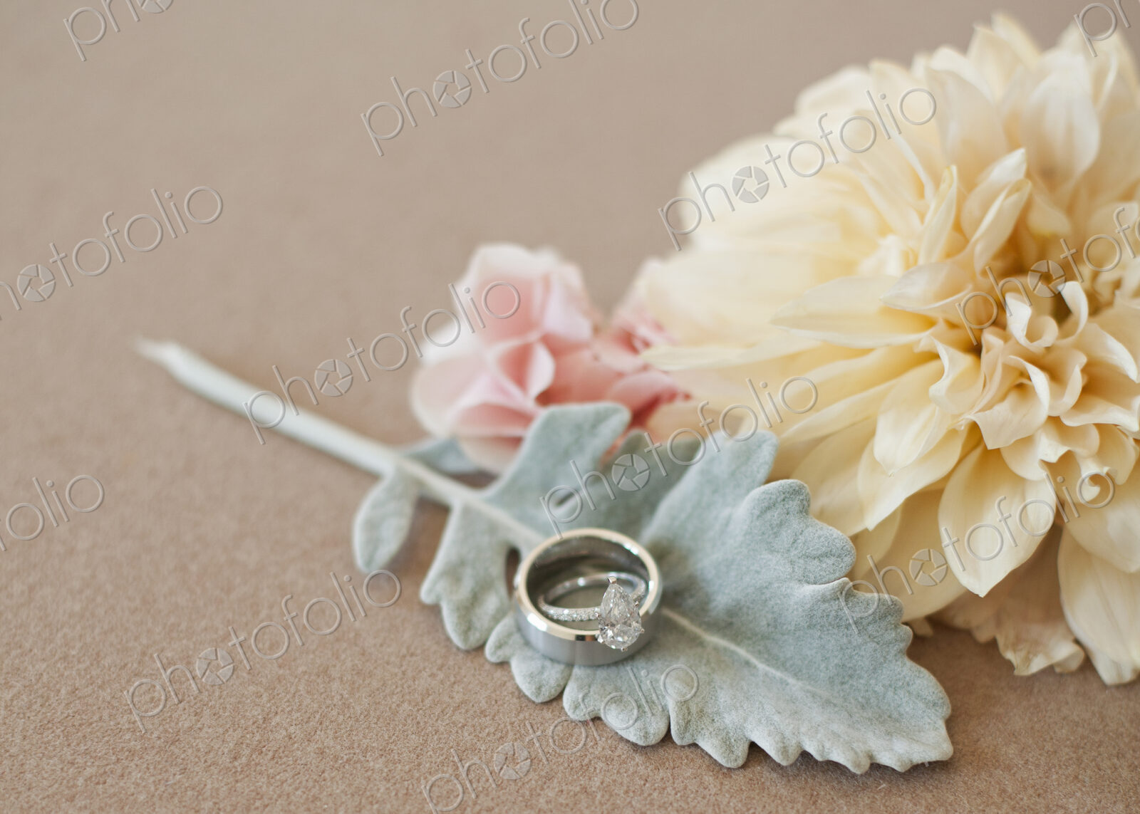 Three decorative accessories for a wedding. Flowers and a leaf shape. A finger ring.