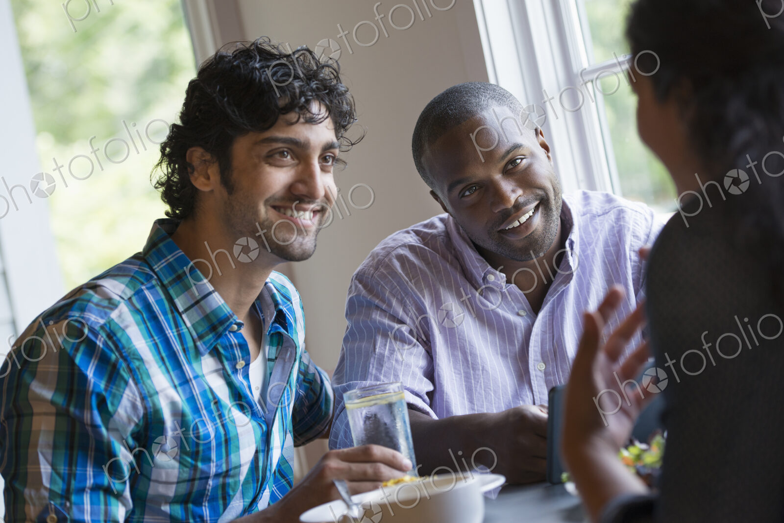 Three people seated at a table.