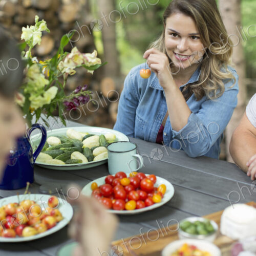 Three people seated outdoors at a meal Three people seated outdoors at a meal