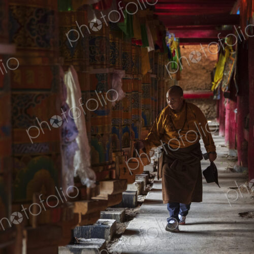 Tibetan Man Turning the Prayer Wheels in the temple at Dongpojia, Sichuan Province,… Tibetan Man Turning the Prayer Wheels in the temple at Dongpojia, Sichuan Province,…