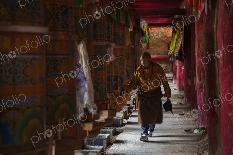 Tibetan Man Turning the Prayer Wheels in the temple at Dongpojia, Sichuan Province,…