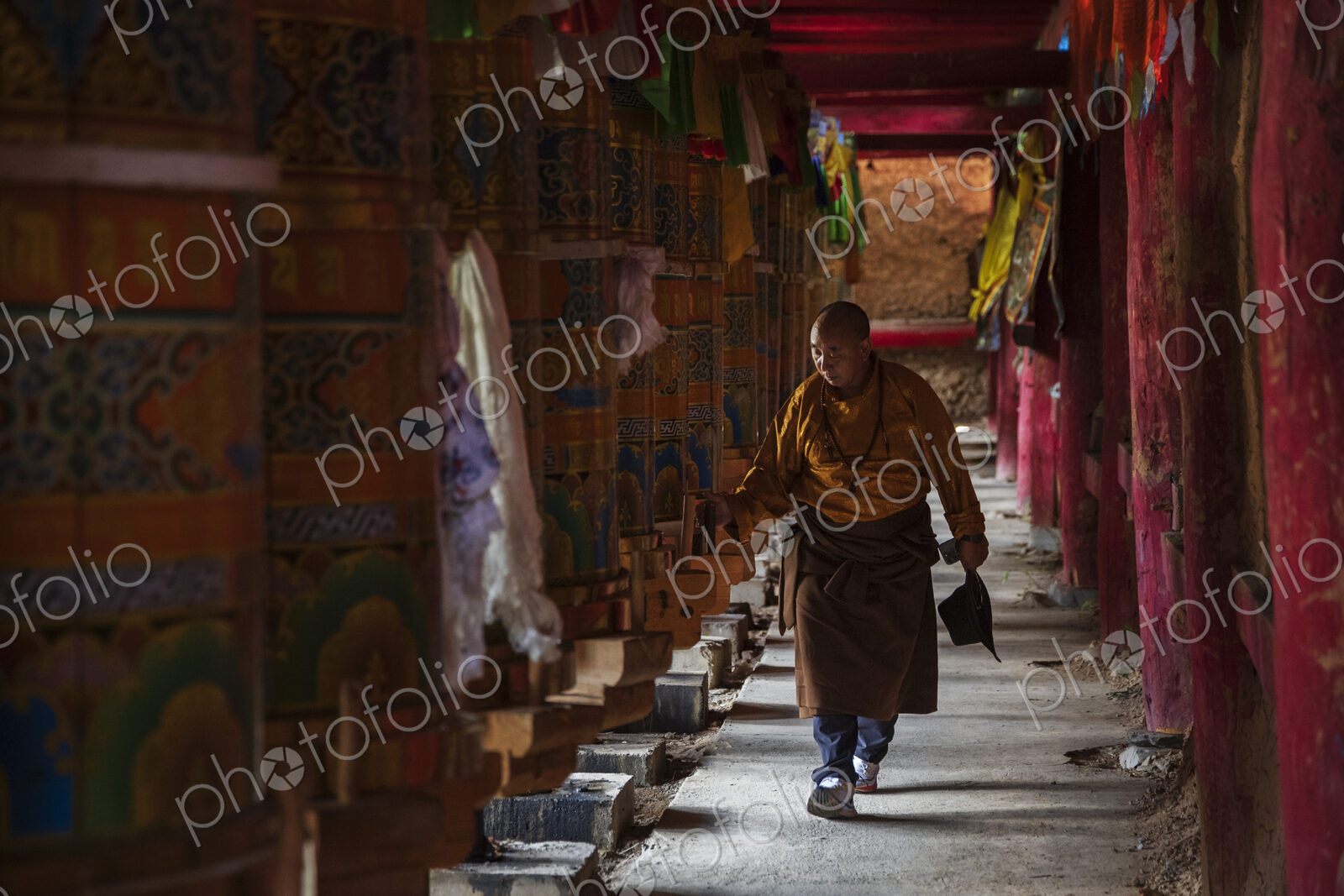 Tibetan Man Turning the Prayer Wheels in the temple at Dongpojia, Sichuan Province,…