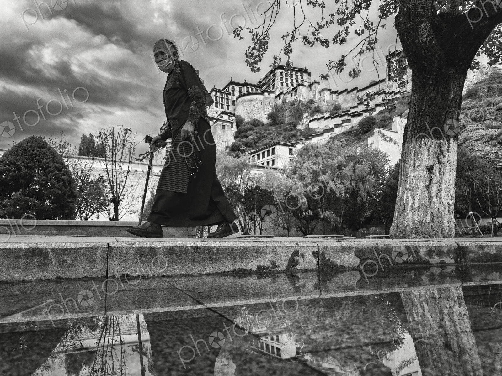 Tibetan Woman Walking Past the Potala Palace Lhasa, Autonomous Region of Tibet