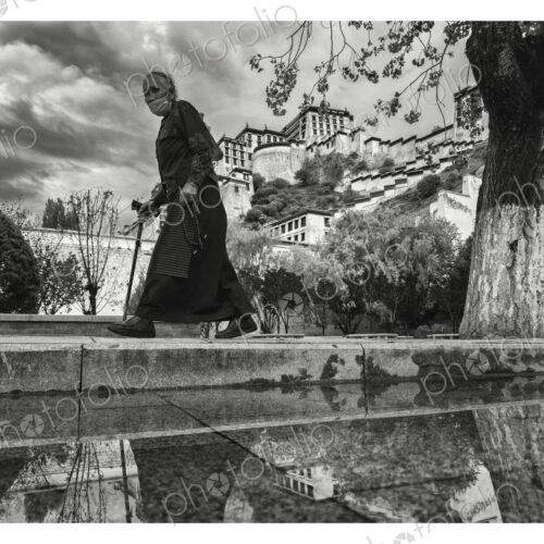 Tibetan Woman Walking Past the Potala Palace Lhasa, Autonomous Region of Tibet