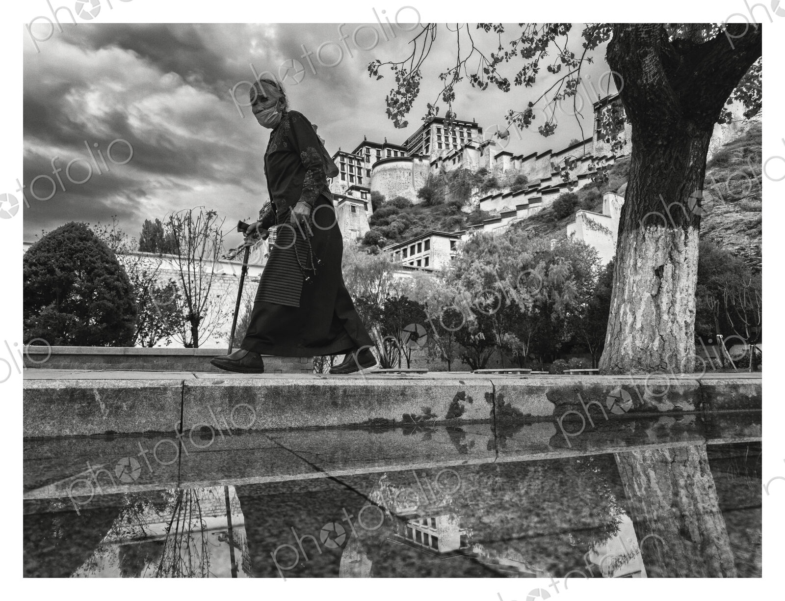 Tibetan Woman Walking Past the Potala Palace Lhasa, Autonomous Region of Tibet