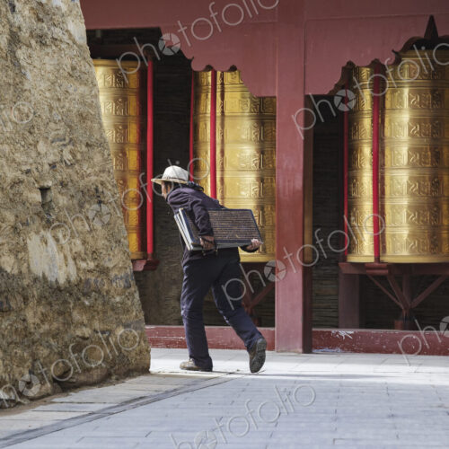 Tibetan Women Carrying inscribed Tablets to be Built into a Mani Wall Tagong, Sichuan… Tibetan Women Carrying inscribed Tablets to be Built into a Mani Wall Tagong, Sichuan…