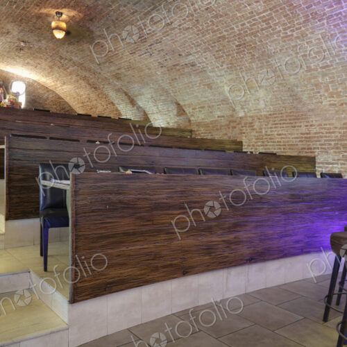 Tiered seats emulating arena in a sports bar.