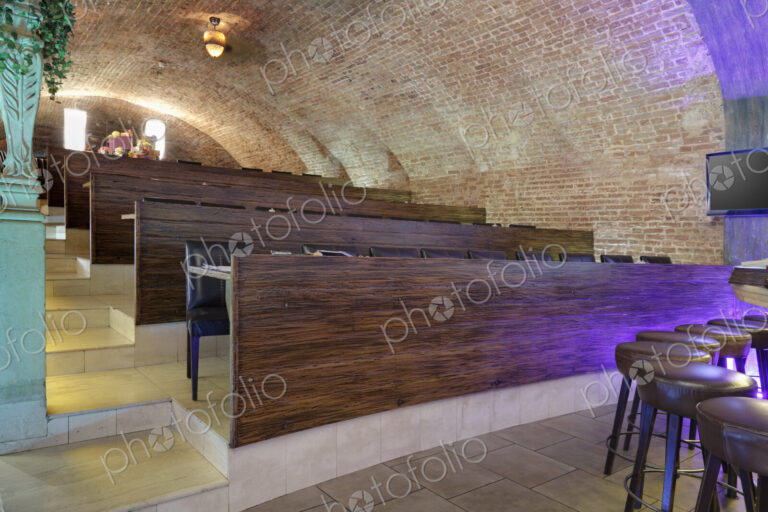 Tiered seats emulating arena in a sports bar.