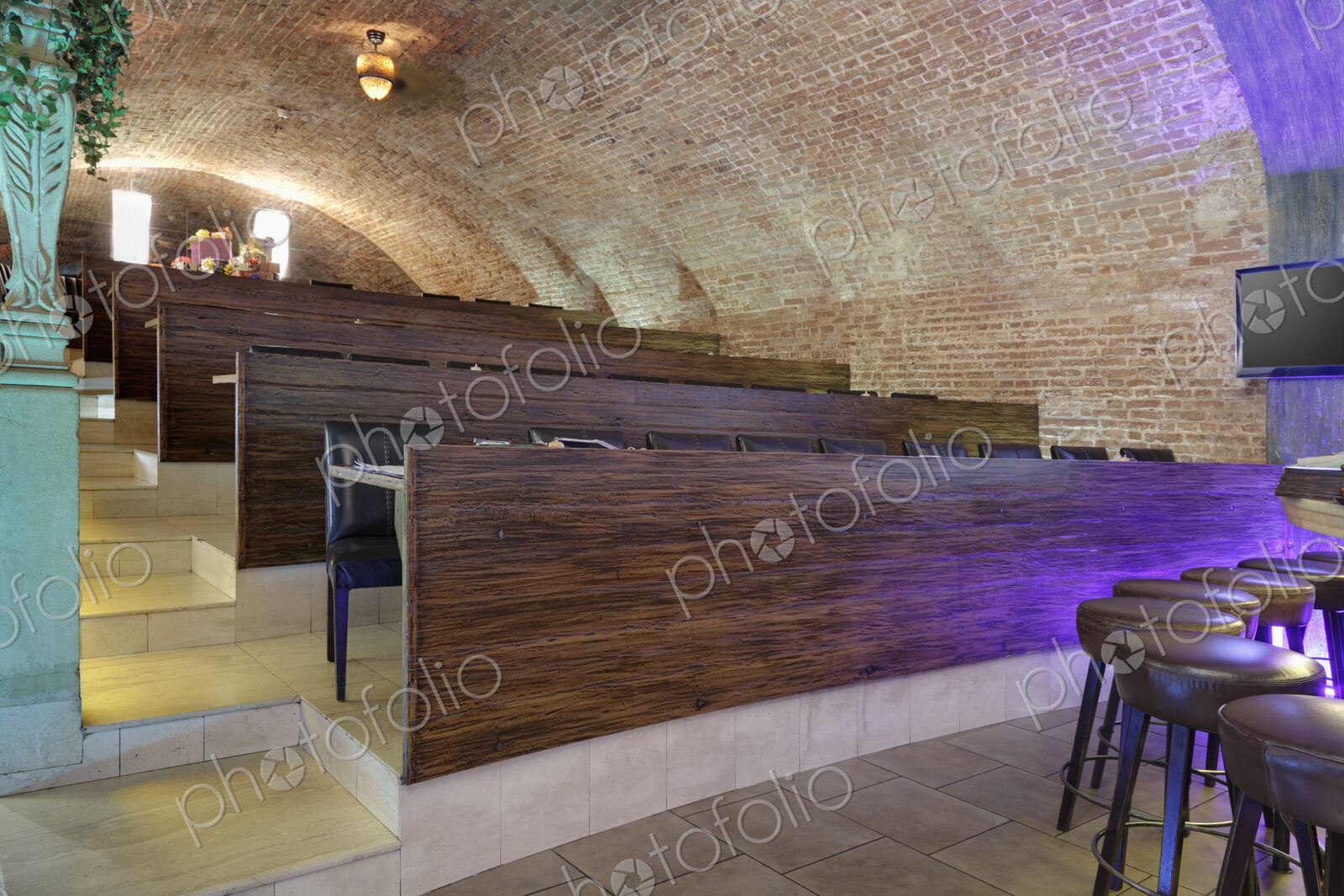 Tiered seats emulating arena in a sports bar.