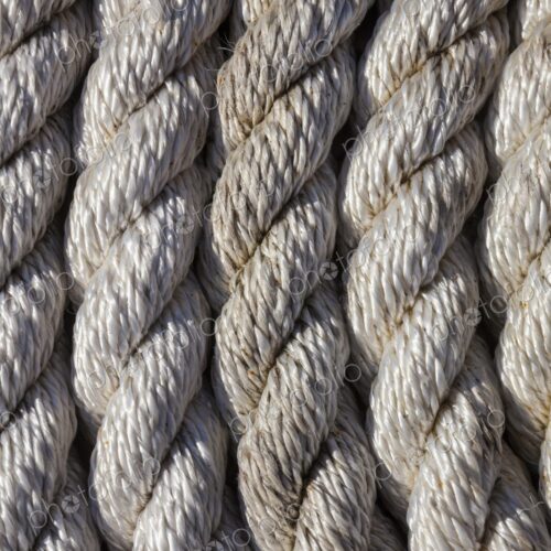 Tightly coiled rope on a dock at Charleston Marina, Oregon, showing detailed texture… Tightly coiled rope on a dock at Charleston Marina, Oregon, showing detailed texture…