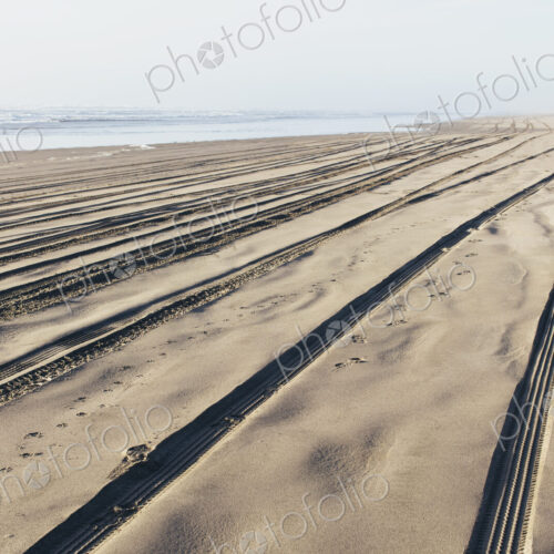 Tire tracks on the soft surface of sand on a beach. Tire tracks on the soft surface of sand on a beach.