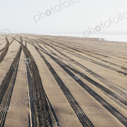 Tire tracks on the soft surface of sand on a beach. Tire tracks on the soft surface of sand on a beach.