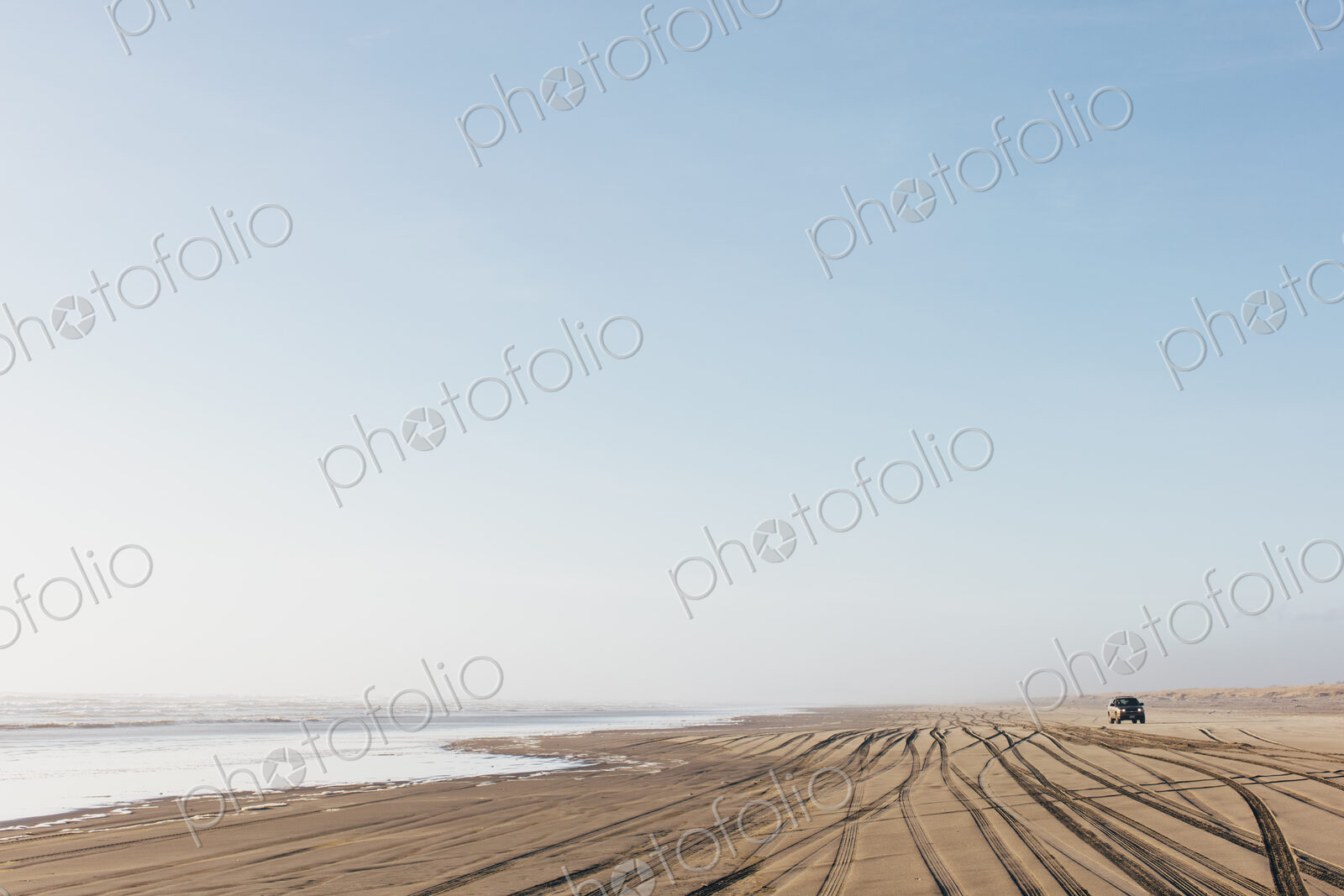 Tire tracks on the soft surface of sand on a beach.