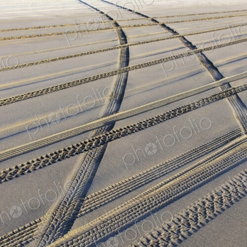 Tire tracks on the soft surface of sand on a beach. Tire tracks on the soft surface of sand on a beach.