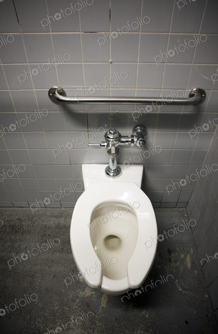Toilet Bowl in a Tiled Restroom