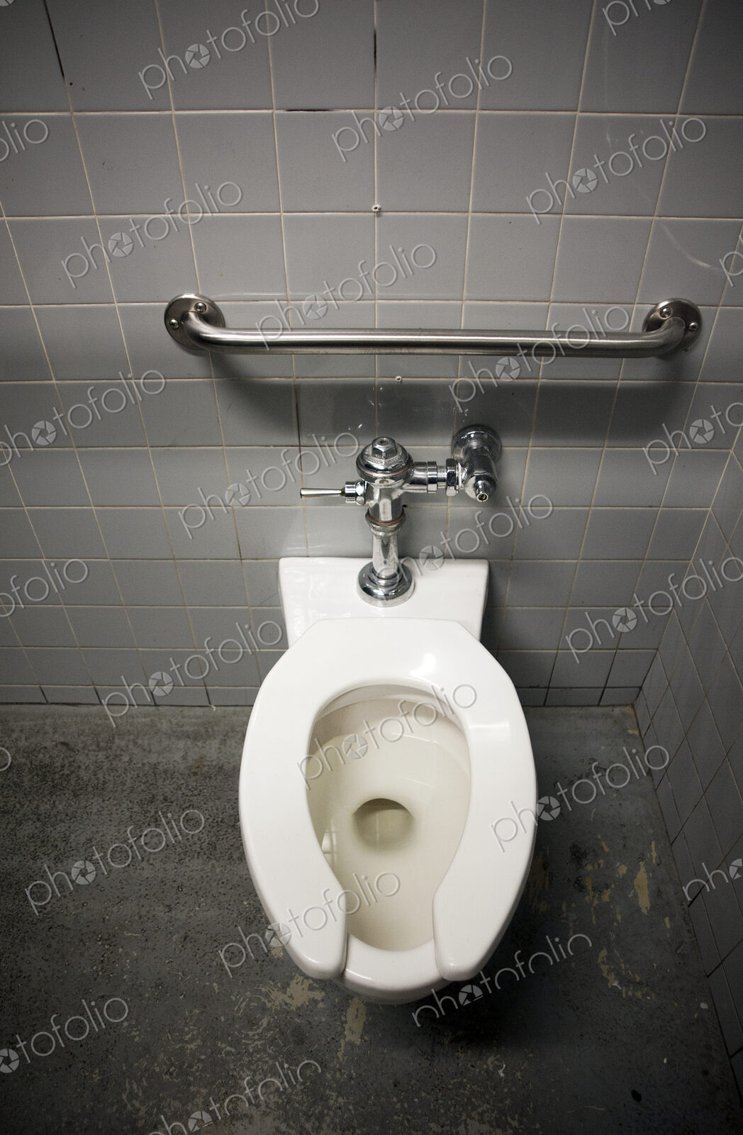 Toilet Bowl in a Tiled Restroom