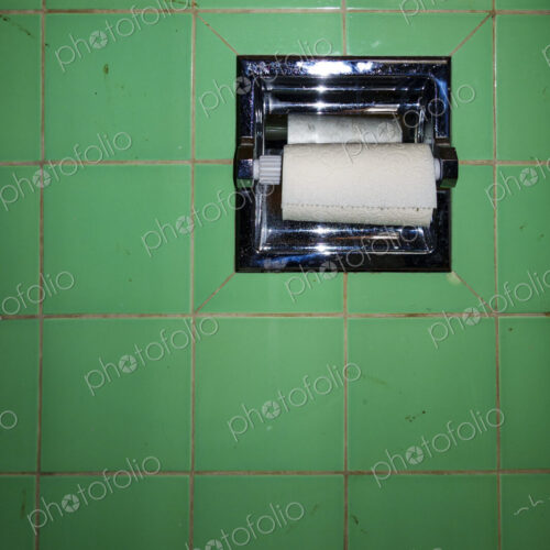 Toilet roll holder with new roll of toilet paper