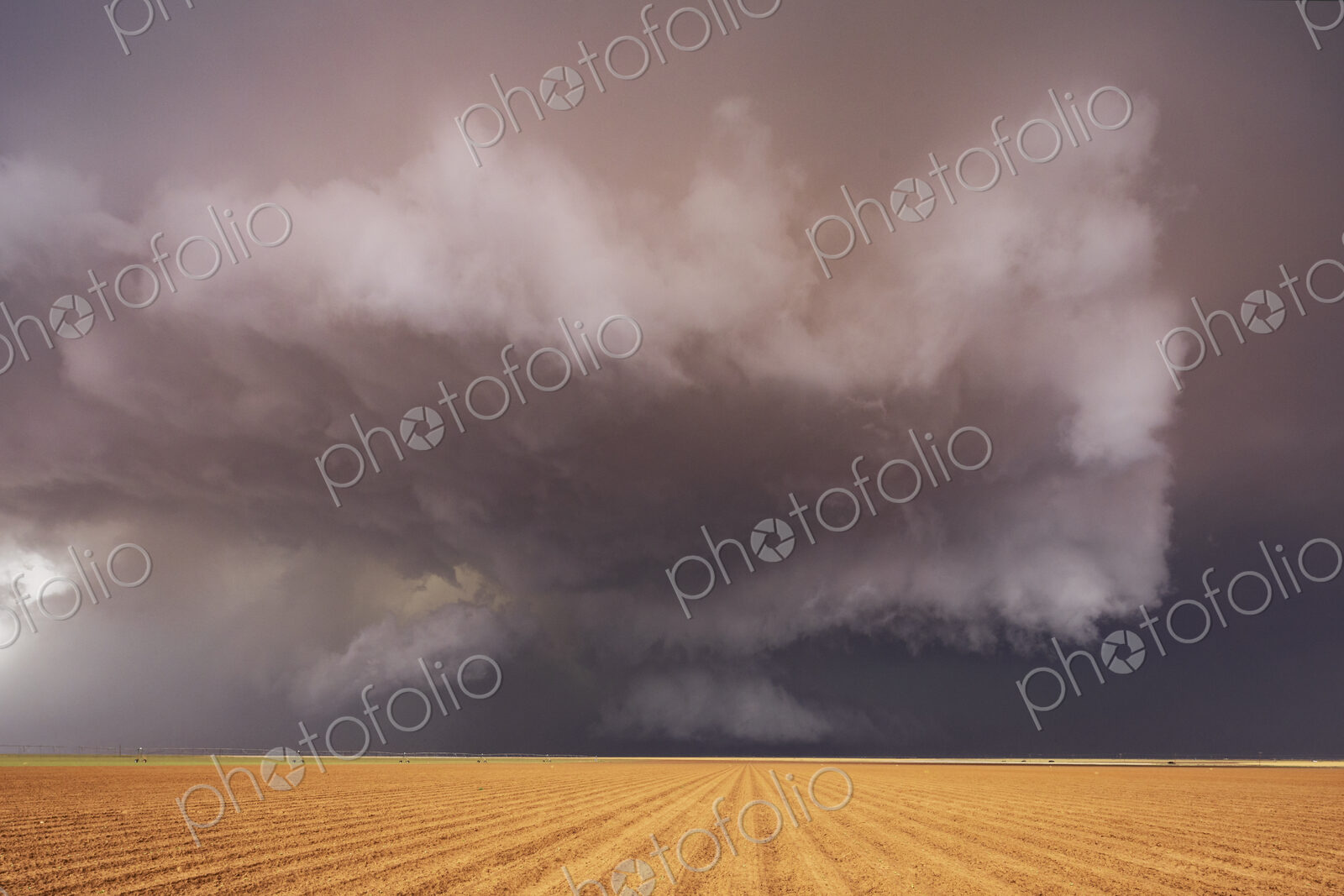 Tornado-Producing Supercell, clouds gathering above a cornfield, dark shapes on the…