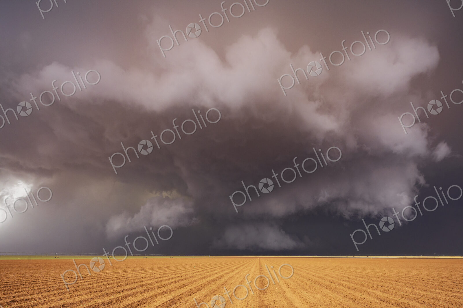 Tornado-Producing Supercell, clouds gathering above a cornfield, dark shapes on the…