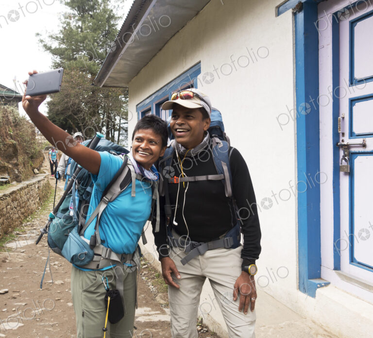 Tourists posing for cell phone selfie