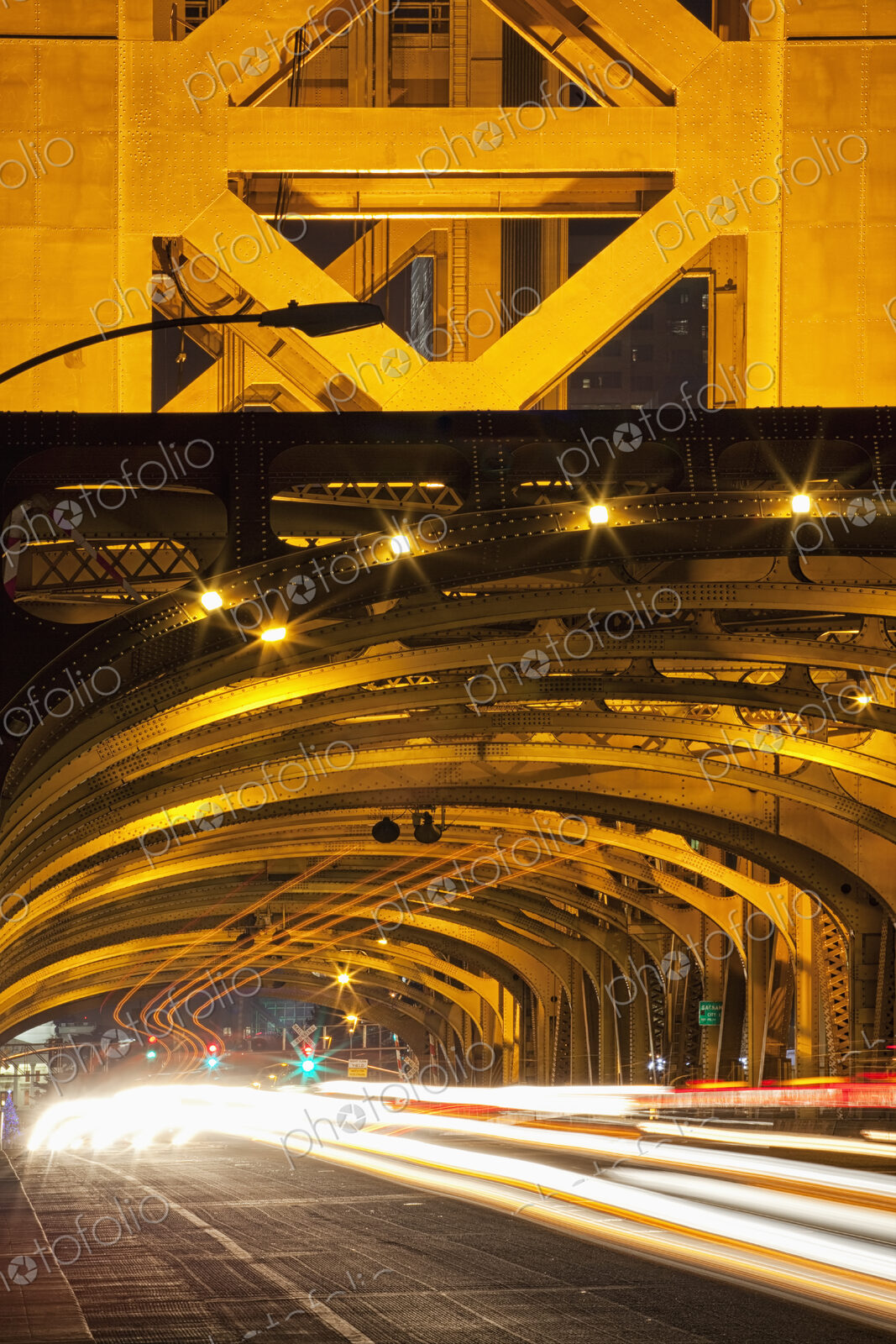 Tower Bridge at night, the roadway across the bridge with curved arches and the…