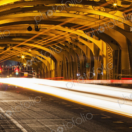 Tower Bridge at night, the roadway across the bridge with curved arches and the… Tower Bridge at night, the roadway across the bridge with curved arches and the…