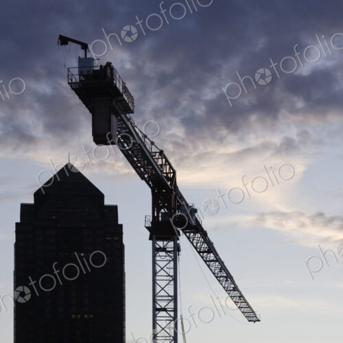 Tower Crane with Building Silhouette in Background Tower Crane with Building Silhouette in Background
