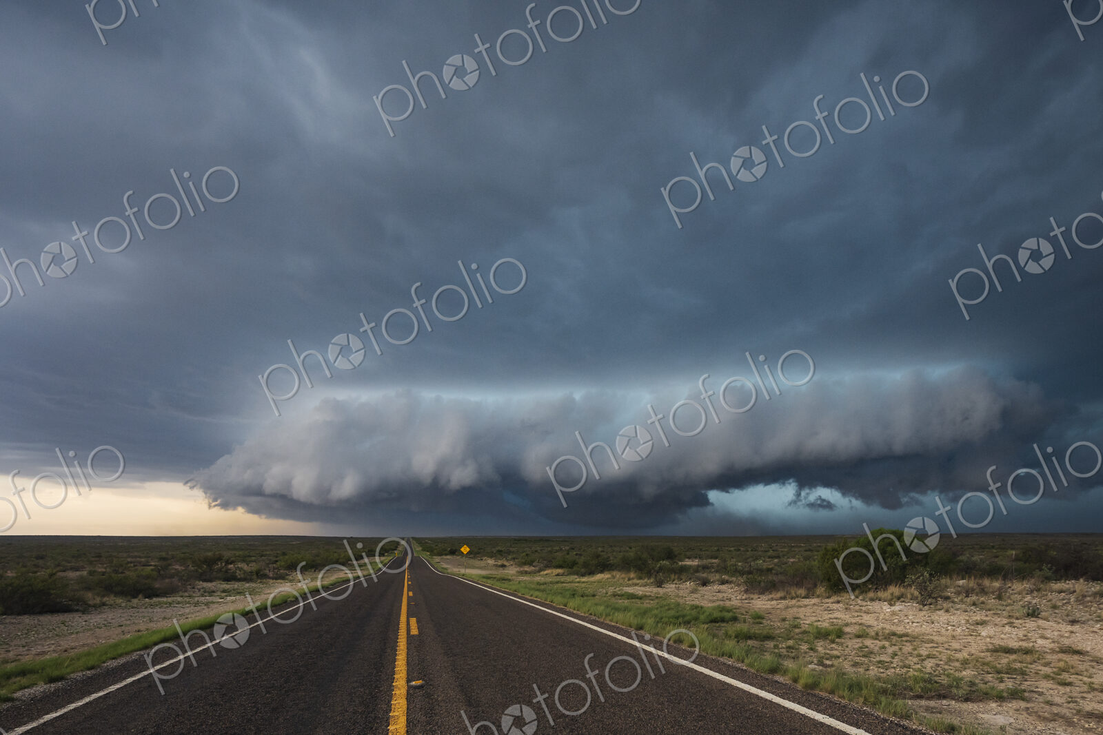 Tracking a Supercell alomg Texas Highway 285, cloud formations hovering over the land.