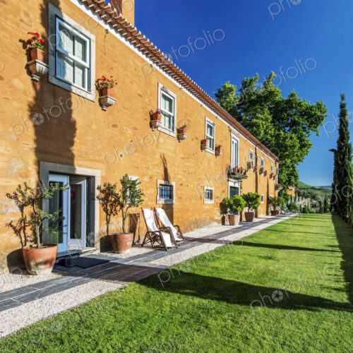 Traditional hotel and grass walkway