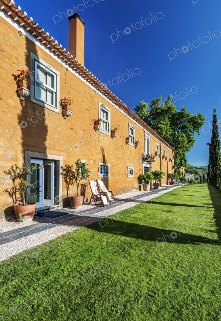 Traditional hotel and grass walkway