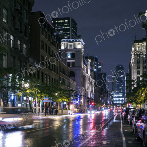 Traffic in wet cityscape at night