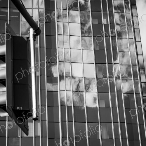 Traffic light and clouds reflected in glass facade in Berlin, Germany. Traffic light and clouds reflected in glass facade in Berlin, Germany.