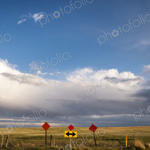 Traffic sign in remote field under clouds Traffic sign in remote field under clouds