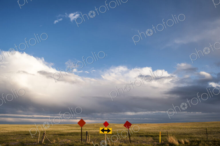 Traffic sign in remote field under clouds