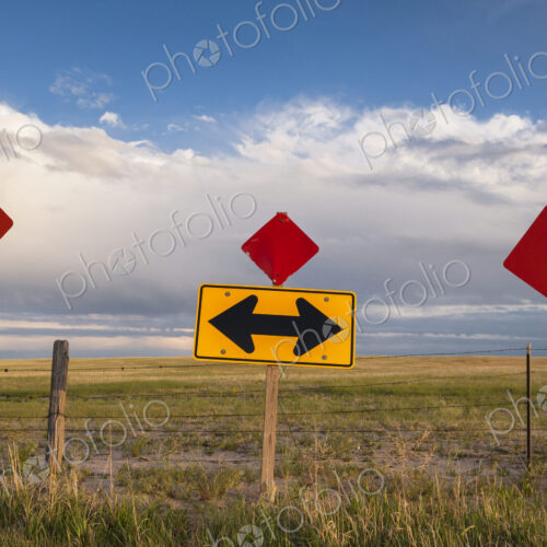 Traffic sign in remote field under clouds Traffic sign in remote field under clouds