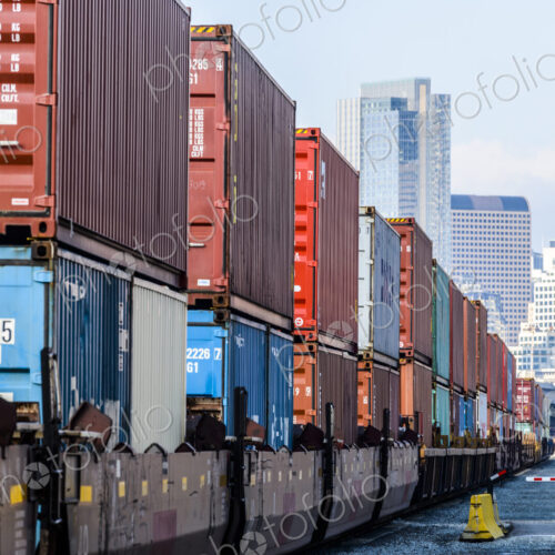 Train carrying containers on train tracks