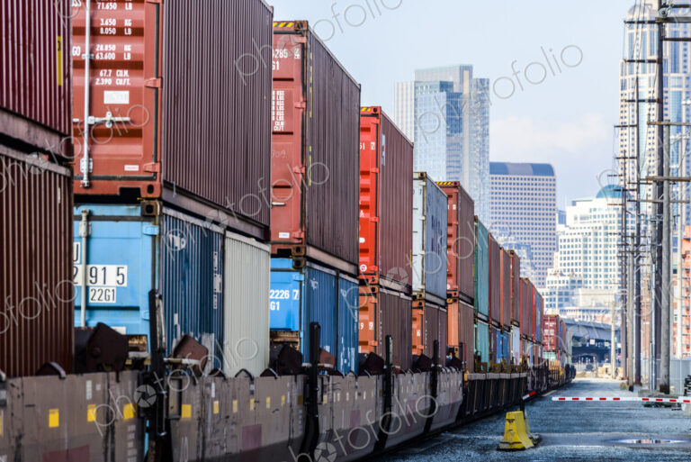Train carrying containers on train tracks