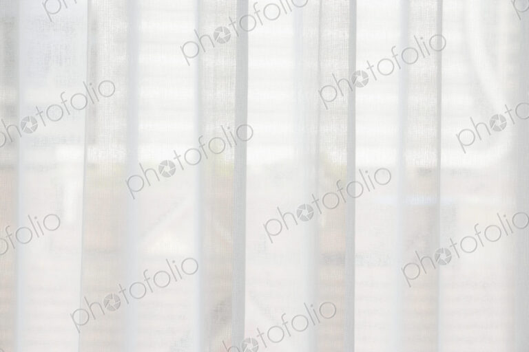 Translucent window blinds or curtains on window.
