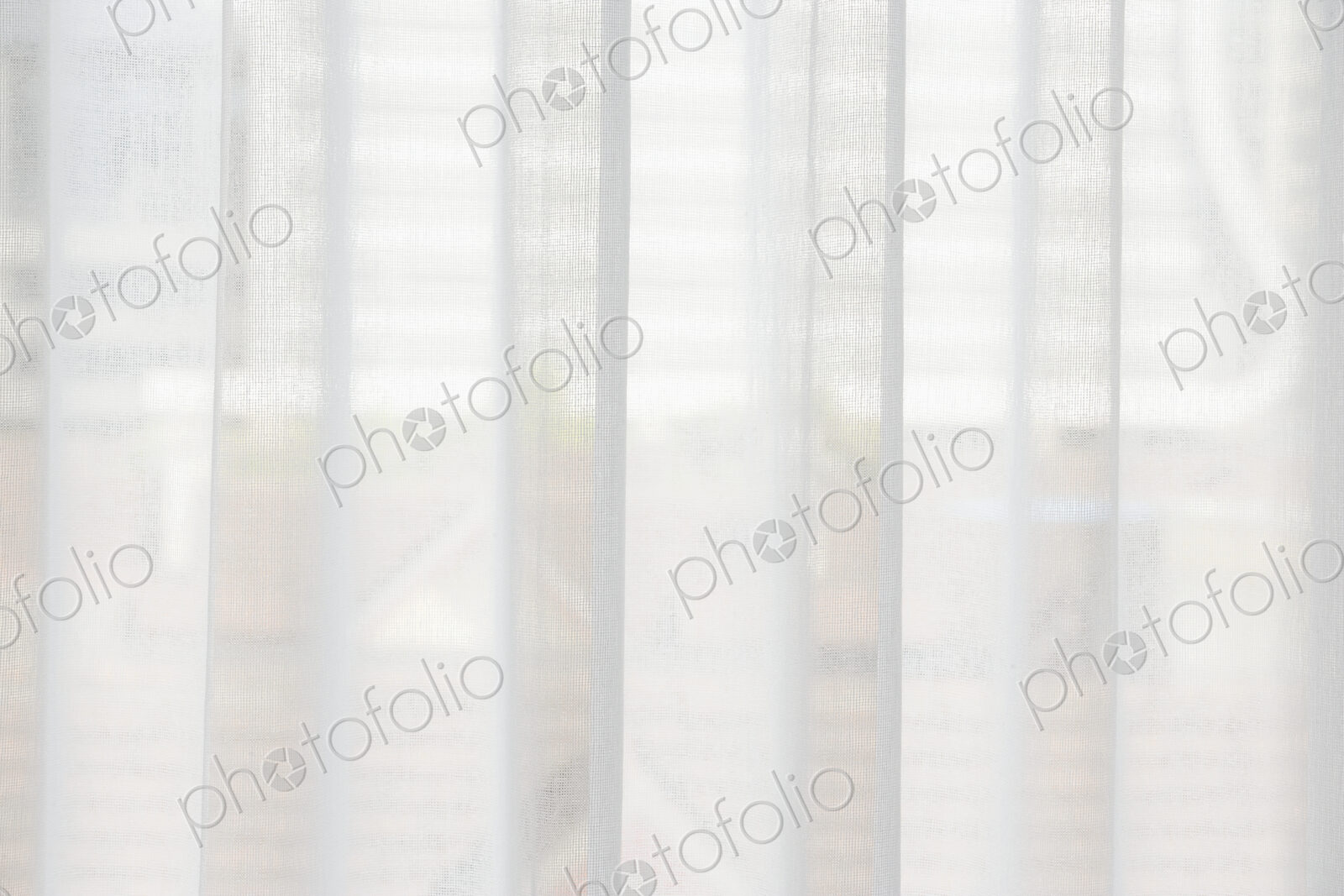 Translucent window blinds or curtains on window.