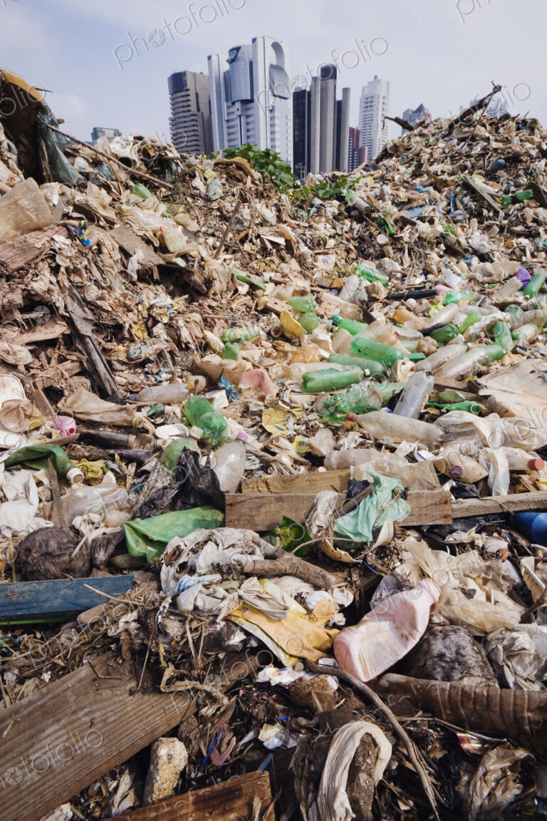 Trash Mound with Modern Office Buildings Behind