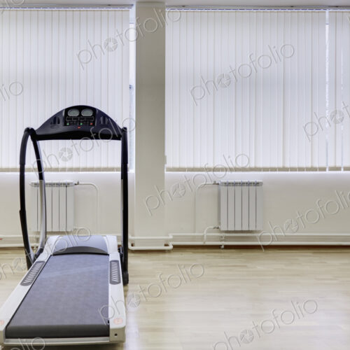 Treadmill running machine in a gymnasium.