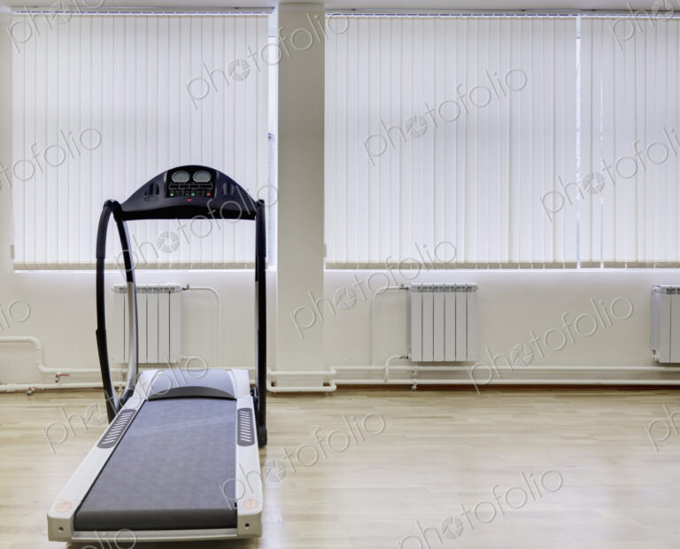 Treadmill running machine in a gymnasium.