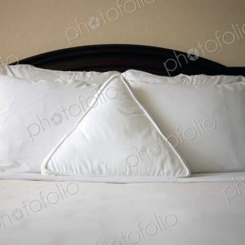 Triangle pillow on bed