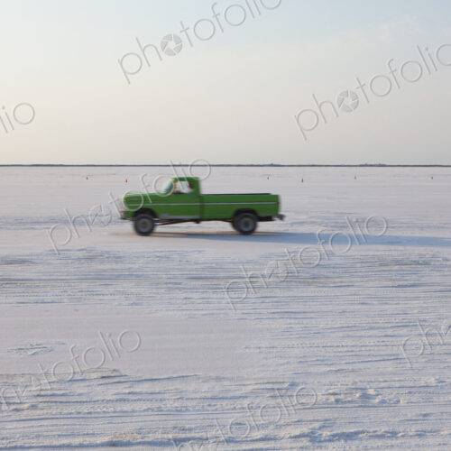 Truck driving on Bonneville Salt Flats, during Speed Week, dusk Truck driving on Bonneville Salt Flats, during Speed Week, dusk