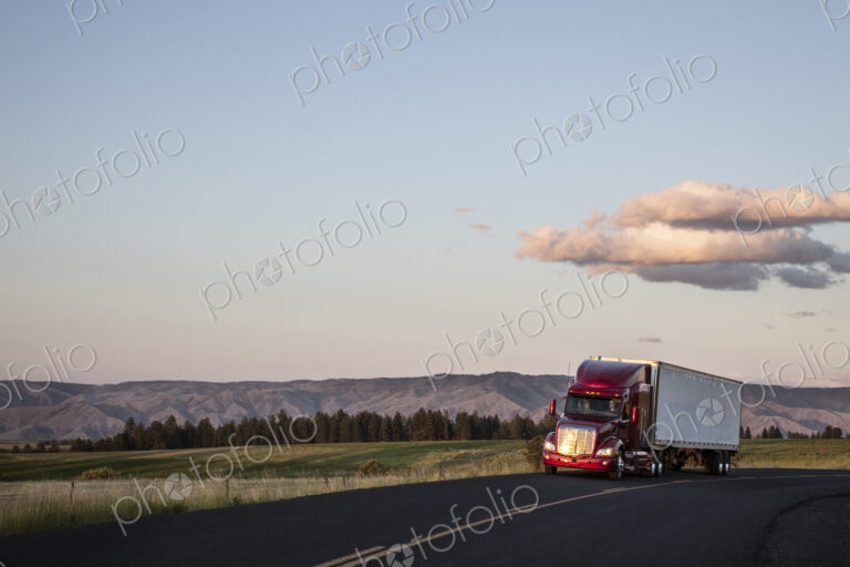 Truck on a highway through the grasslands area of eastern Washington, USA.