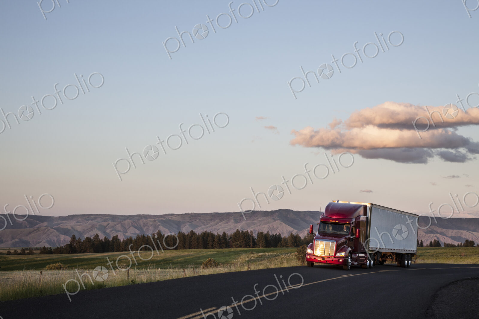 Truck on a highway through the grasslands area of eastern Washington, USA.