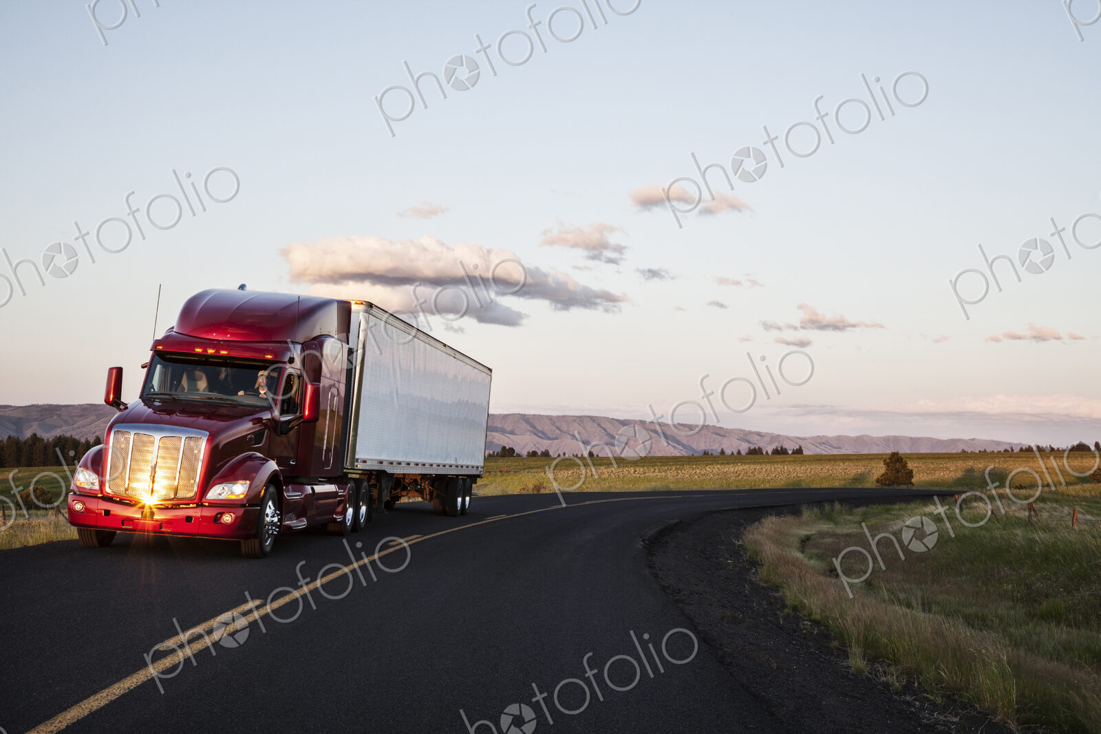 Truck on a highway through the grasslands area of eastern Washington, USA.