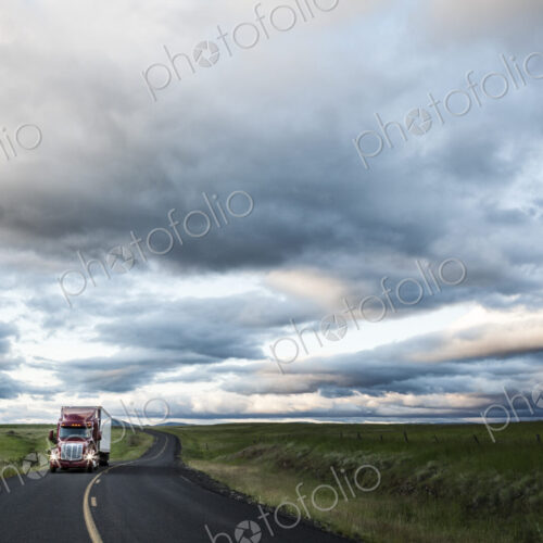 Truck on a highway through the grasslands area of eastern Washington, USA.