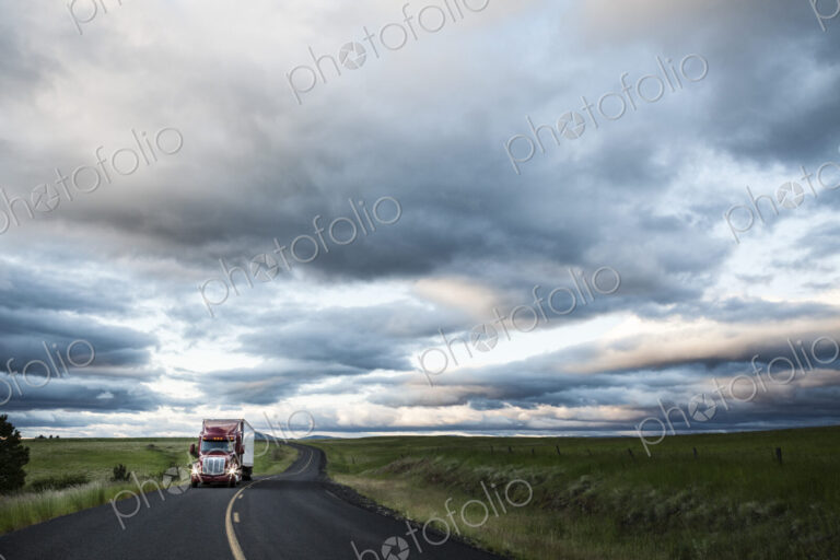 Truck on a highway through the grasslands area of eastern Washington, USA.