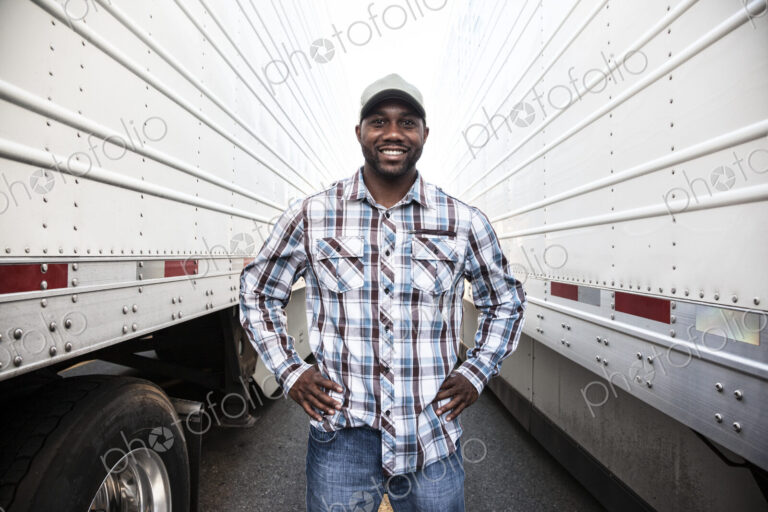 Trucker standing by his large truck